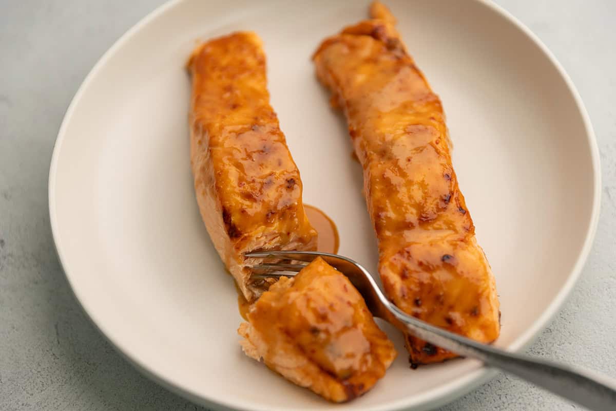 bang bang salmon on a white plate