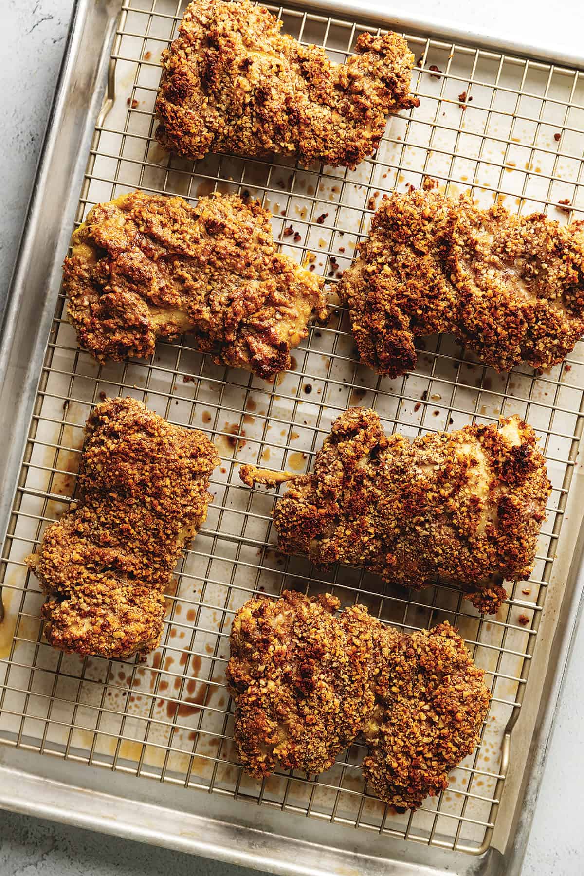 pecan crusted chicken thighs on a sheet pan