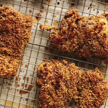 pecan crusted chicken thighs on a wire rack
