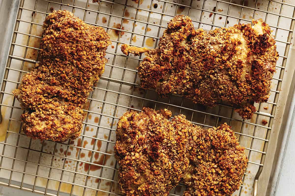 pecan crusted chicken thighs on a wire rack