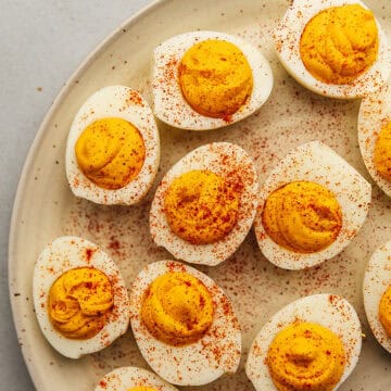 a plate full of spicy deviled eggs