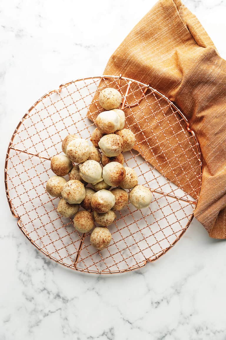 Cinnamon roll energy bites on a cooling rack