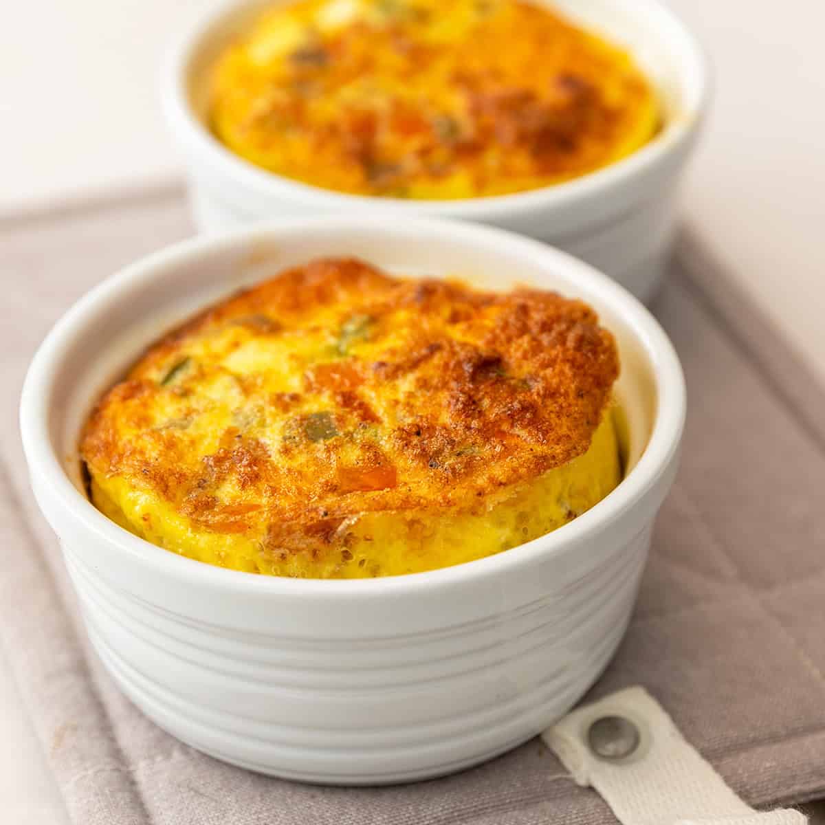 Creamy cheesy baked keto eggs in ramekins for low carb breakfast or snack. Perfect for keto, Atkins, and low carb diets.