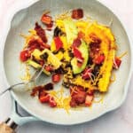 eggs with bacon and avocado in a skillet