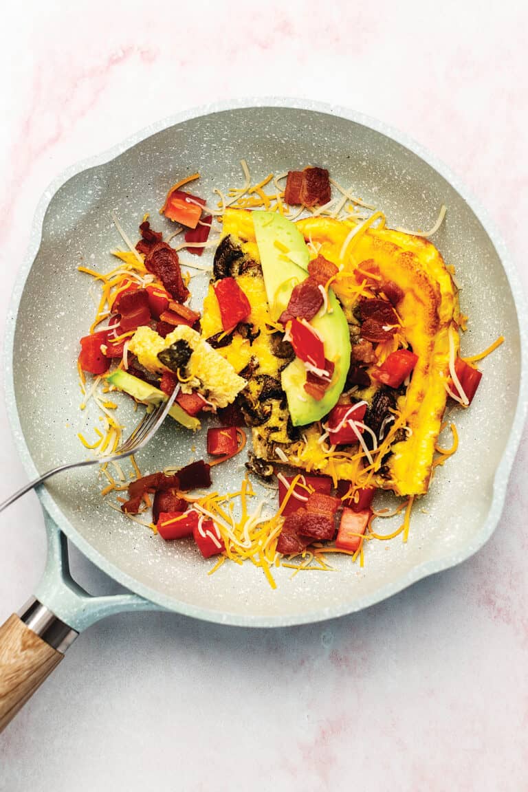 eggs with bacon and avocado in a skillet