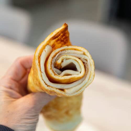 holding a rolled up cottage cheese flatbread