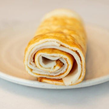 a flatbread wrap made with cottage cheese rolled up on a plate