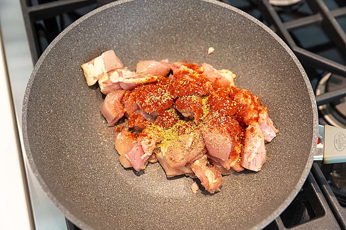 seasoned chicken thighs in a non stick skillet