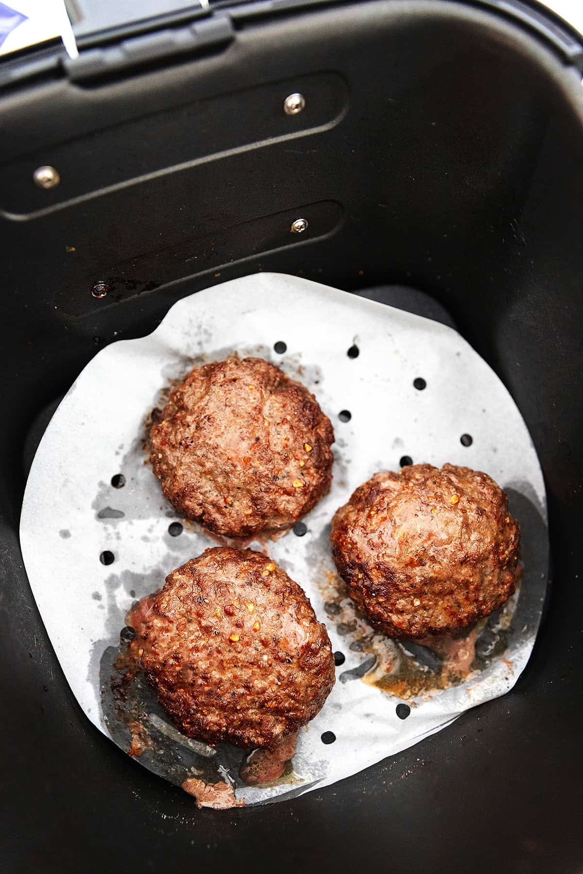 3 burgers cooked in an air fryer 