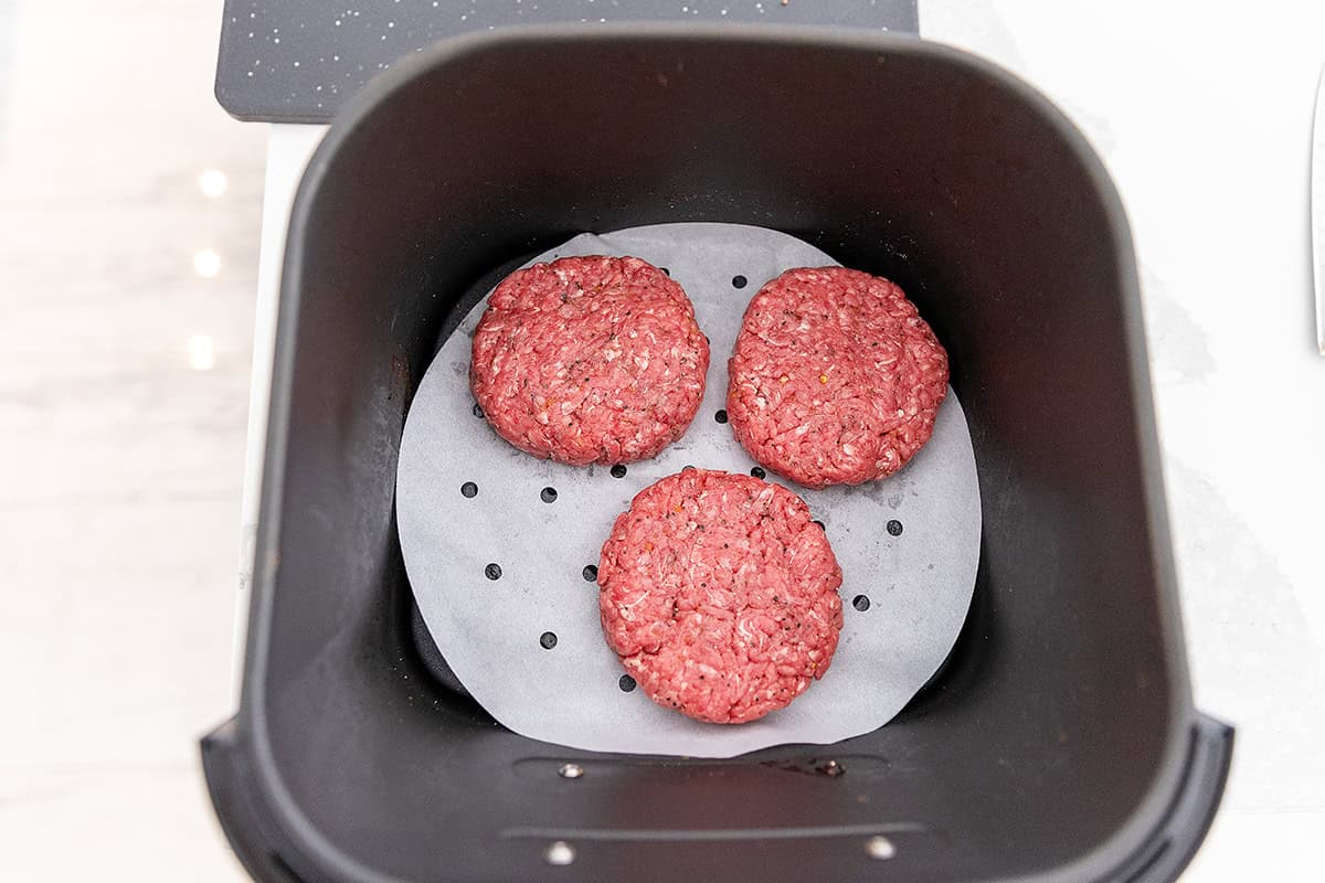 homemade hamburger patties in air fryer basket