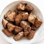 finished air fryer steak bites in a white bowl