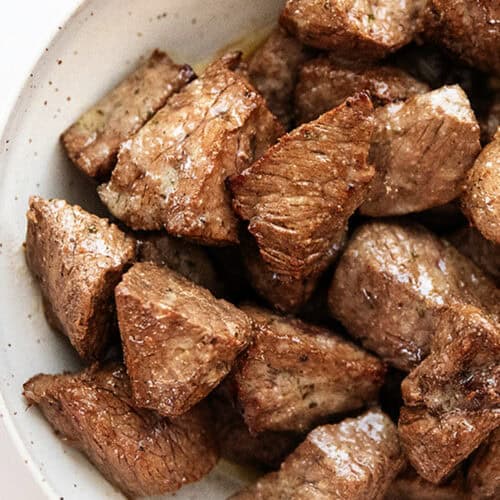 a bowl full of air fryer steak bites with garlic butter