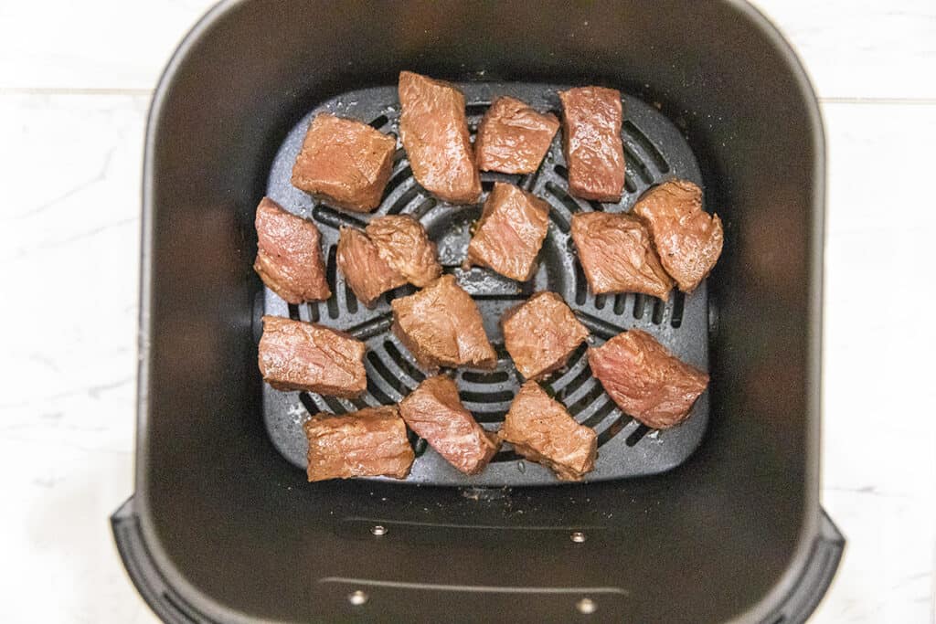 steak bites in an air fryer basket