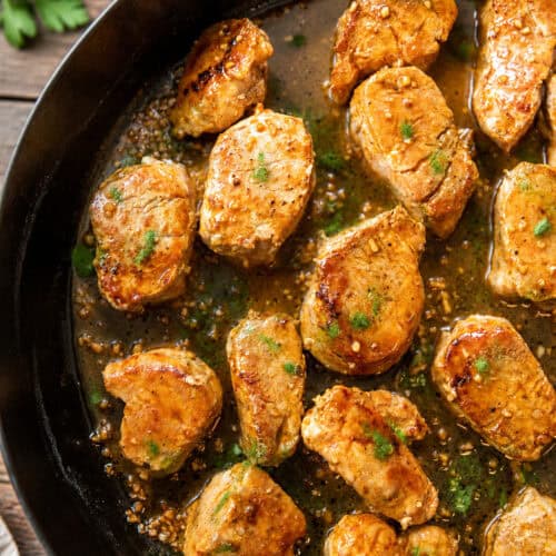 Pork medallions in garlic butter sauce in a skillet