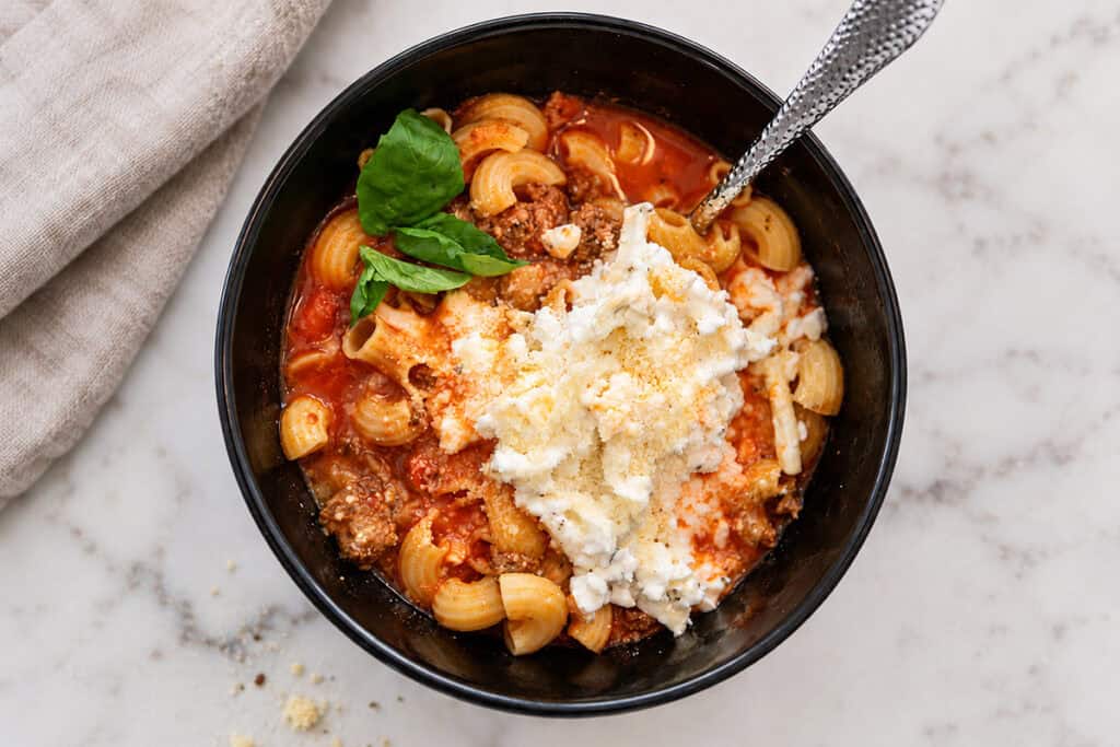 high protein lasagna soup in a bowl with cottage cheese