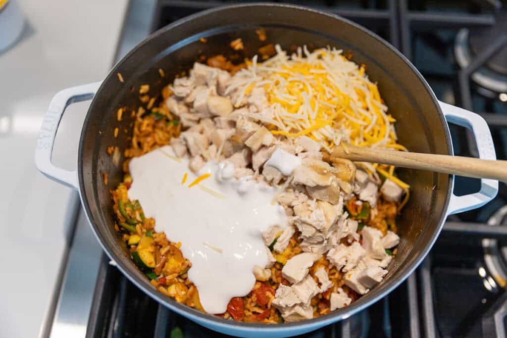 all of the ingredients for chicken taco casserole in a large pot including blended cottage cheese.