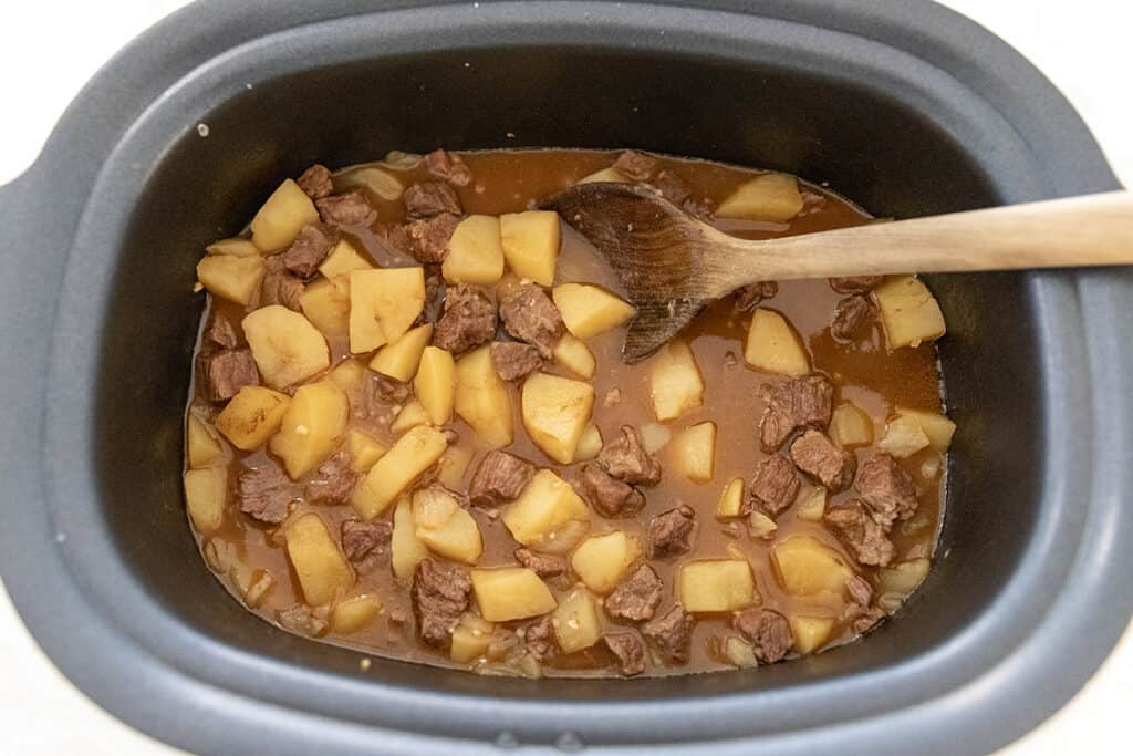 cooked potatoes beef and broth in a slow cooker